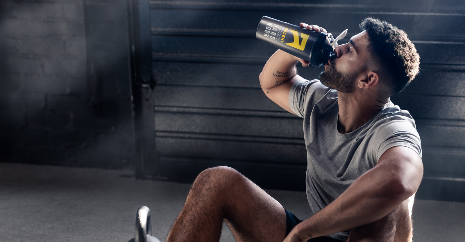 Athlete drinking from blender bottle